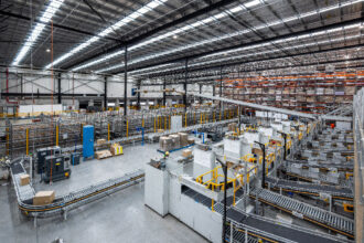 A vast, well-lit warehouse interior with organized conveyor belts and stacked boxes, showcasing automated logistics and efficient space utilization.