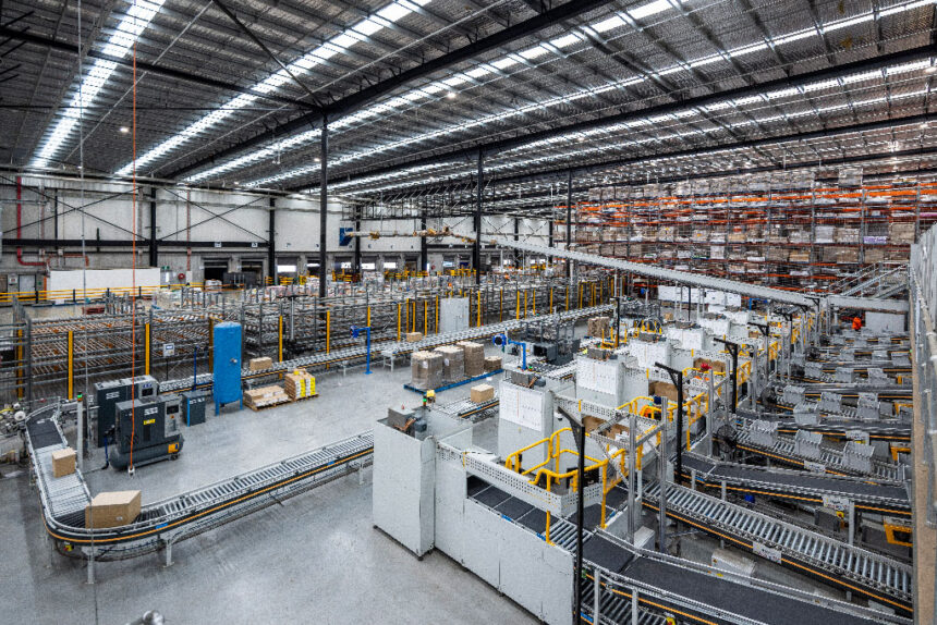 A vast, well-lit warehouse interior with organized conveyor belts and stacked boxes, showcasing automated logistics and efficient space utilization.