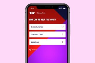 Smartphone screen displaying a banking app interface with options for Quick Balance, Cardless Cash, and Locate Us against a red and purple gradient background.