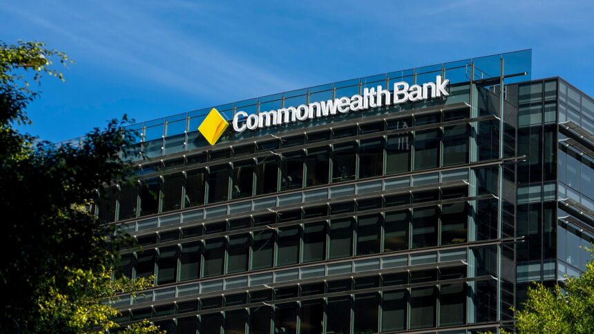 Commonwealth Bank office building with modern glass exterior and company logo displayed on the top facade, photographed during the day.