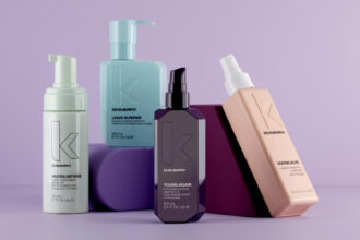 Kevin Murphy haircare products displayed on purple geometric blocks against a soft lavender background.