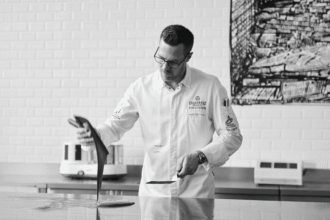Ryan Stevenson works with chocolate on a marble bench in a Callebaut kitchen.