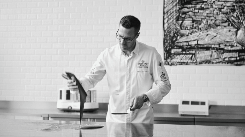 Ryan Stevenson works with chocolate on a marble bench in a Callebaut kitchen.