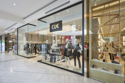 Cue clothing store in an Australian shopping centre, featuring a glass storefront, fashion mannequins and clothing displays.