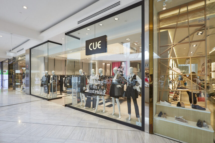 Cue clothing store in an Australian shopping centre, featuring a glass storefront, fashion mannequins and clothing displays.